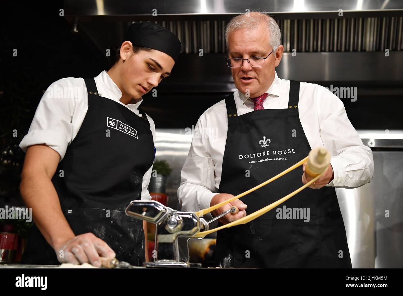 Prime Minister Scott Morrison (centre) is taught to make pasta by