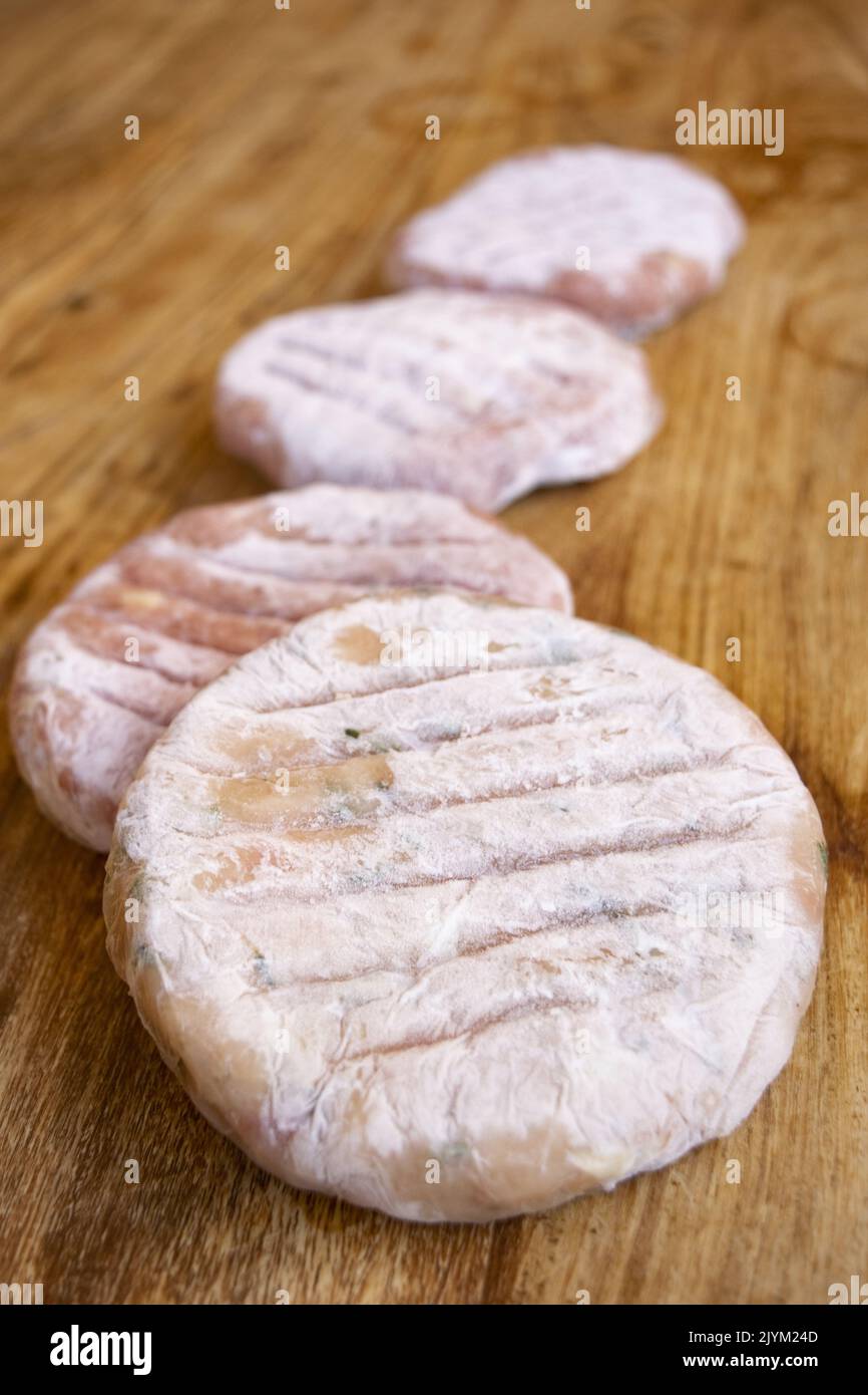 Homemade frozen burgers wrapped in cling film Stock Photo