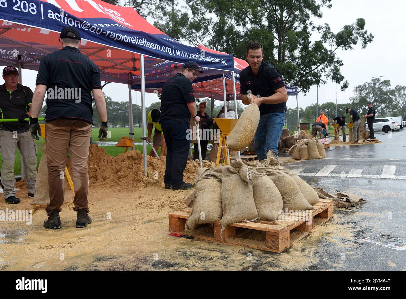 Rapid Relief Team (RRT) members are seen preparing sandbags in Penrith