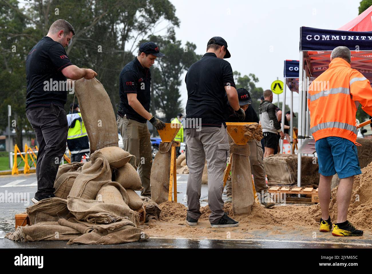 Rapid Relief Team (RRT) members are seen preparing sandbags in Penrith