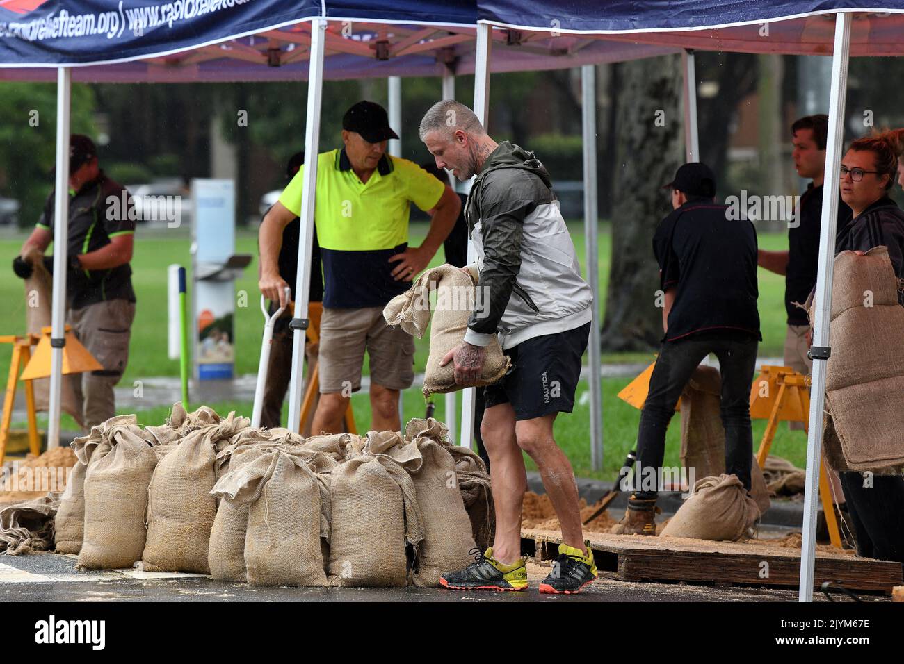 Rapid Relief Team (RRT) members are seen preparing sandbags in Penrith
