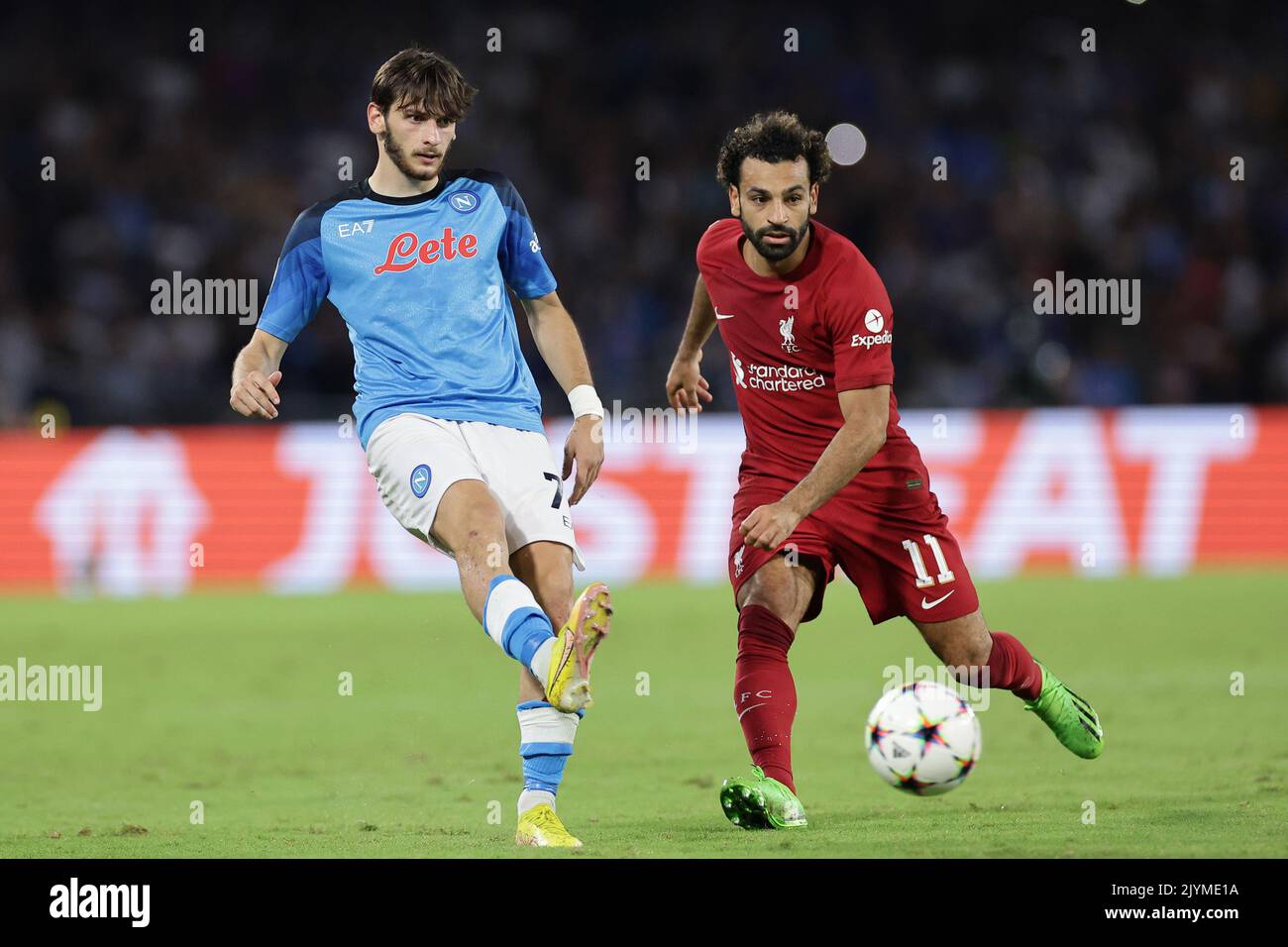 Khvicha Kvaratskhelia of SSC Napoli and Mohamed Salah of Liverpool FC  compete for the ball during the Champions League Group A football match between Stock Photo