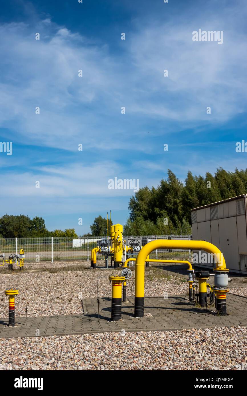 Yellow pipes and valves of natural gas transmission installations. The high price of the raw material is killing business. Photo taken on a sunny day Stock Photo