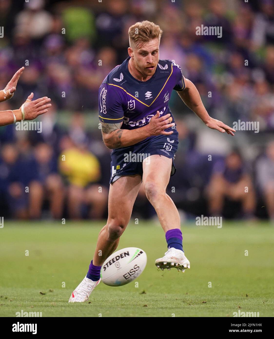 Cameron Munster of the Melbourne Storm runs with the ball during the Round  6 NRL match between the Melbourne Storm and Sydney Roosters at AAMI Park in  Melbourne, Friday, April 16, 2021. (