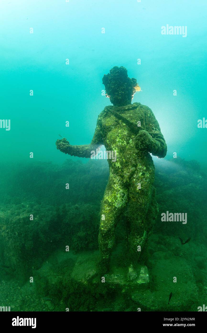 Statue of Dionysus with ivy crown, god of intoxication and happiness. Located in the submerged Nymphaeum of Emperor Claudius, near Punta Epitaffio , Marine Protected Area of Baia, Naples, Italy, Tyrrhenian Sea Stock Photo