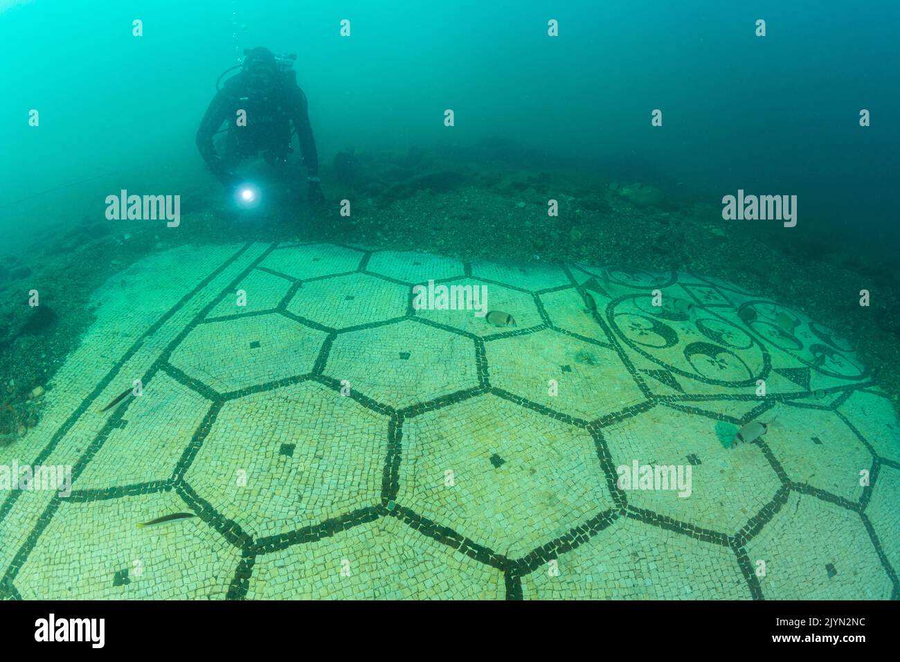 Scuba diver exploring a splendid mosaic (tessellatum) in black and white decorated with a pattern of hexagons, perfectly preserved, Villa a Protiro, Marine Protected Area of Baia, Naples, Italy, Tyrrhenian Sea Stock Photo