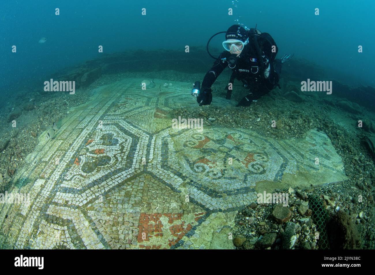 Scuba diver exploring a polychrome mosaics in the thermal complex of ...