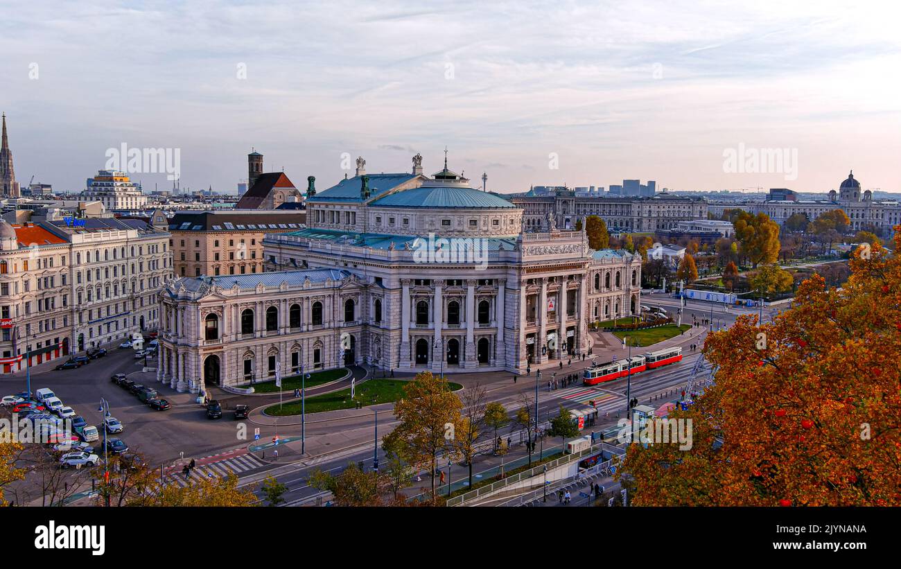 Elevated view of the Burgtheater The Burg in Vienna Austria ft beautiful aerial cityscape at dusk. Flying by worldwide famous historical landmark arou Stock Photo