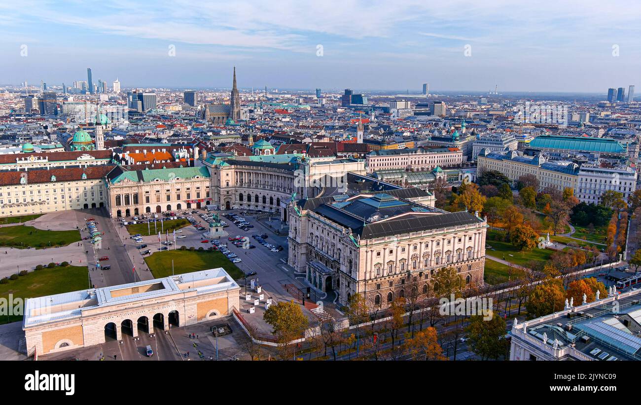 Flying over beautiful Hofburg Palace in Vienna at sunset autumn day. Located in the centre of Austria capital along famous historical city landmarks. Stock Photo