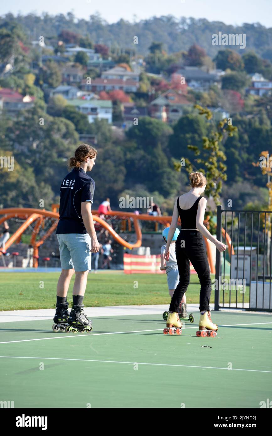 People are seen rollerblading and rollerskating at Riverbend Park in