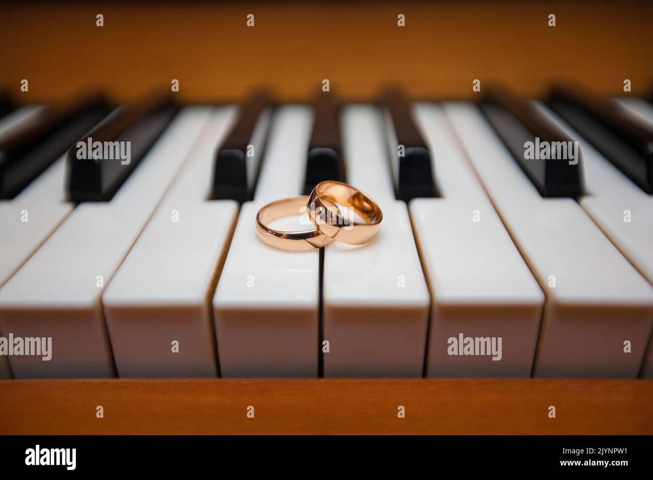 Gold wedding rings on the piano keys Stock Photo Alamy