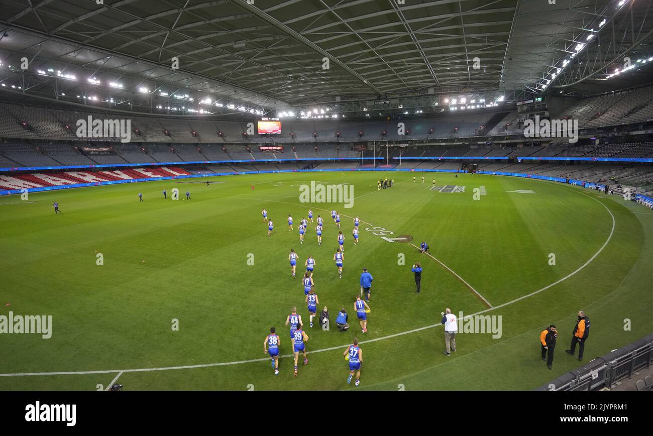 The Bulldogs run onto the field in an empty stadium during the Round 11
