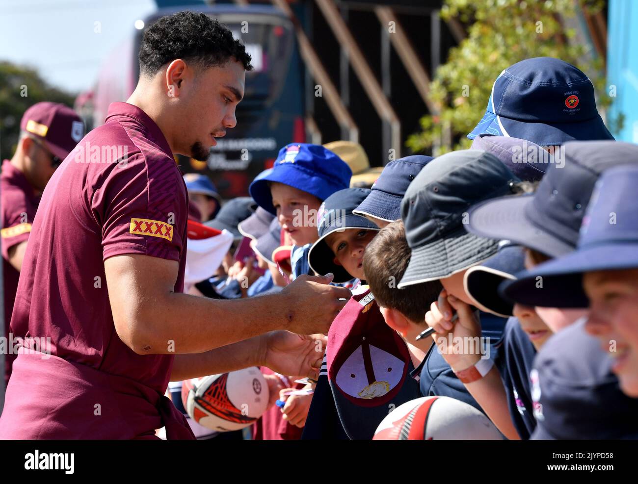 Xavier Coates (left) is seen with fans during the Queensland Maroons State of Origin fan day at Xavier Coates (left) is seen with fans during the Queensland Maroons State of Origin fan day at
