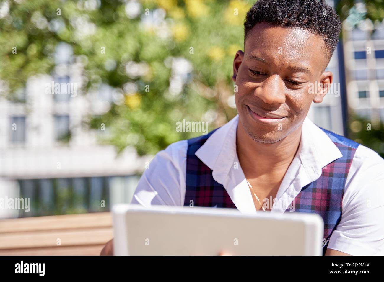 close-up of an African-American juvenile using his tablet pc Stock Photo