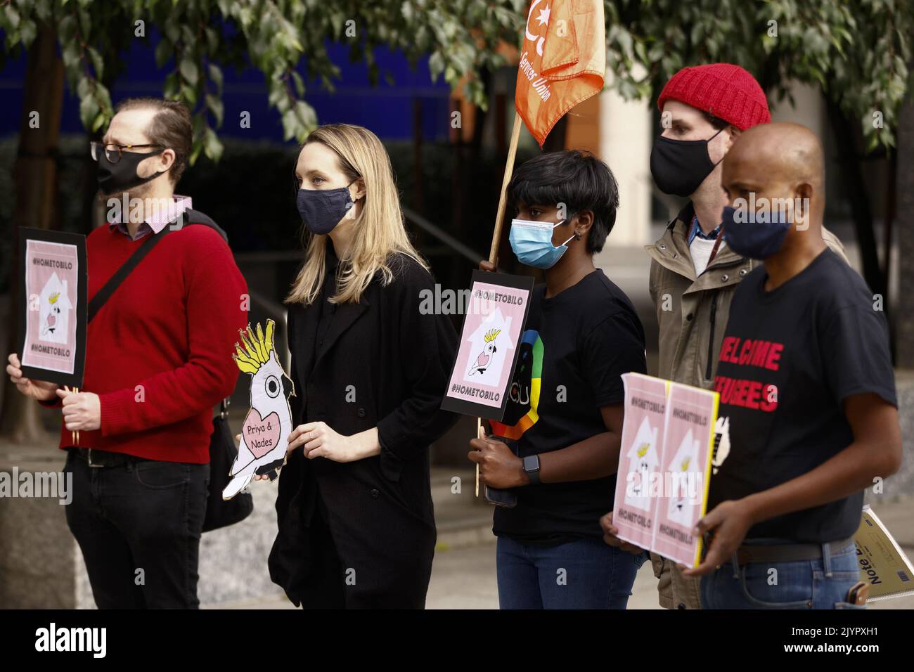 Members of the Health and Community Services Union are seen during a press conference at the