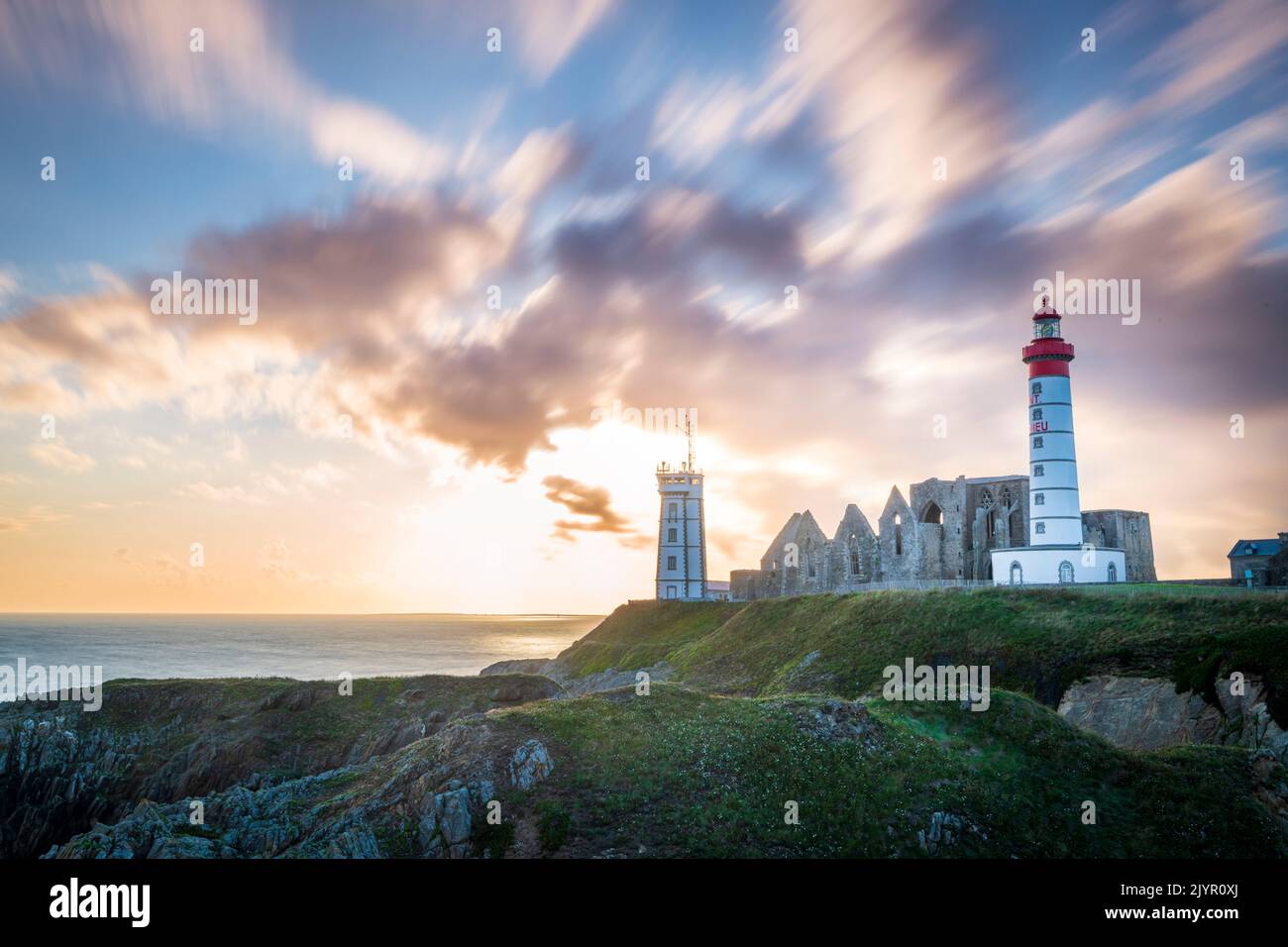 Saint-Mathieu lighthouse at sunset in summer, Finistere, France Stock Photo