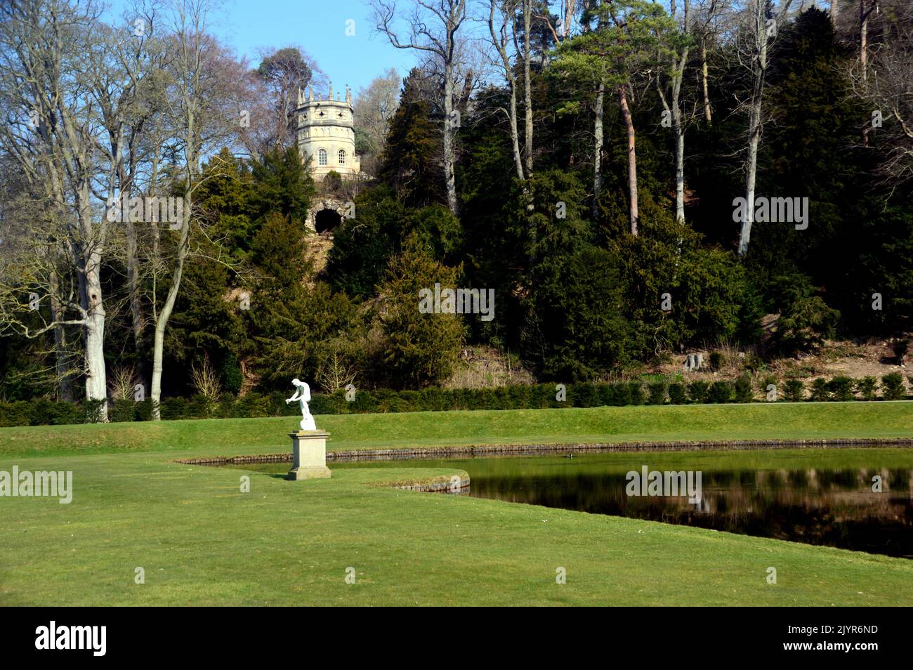The Statue of Galen and the Octagon Tower (Folly) by Crescent Pond at Fountains Abbey and Studley Royal Water Garden, North Yorkshire, England, UK. Stock Photo
