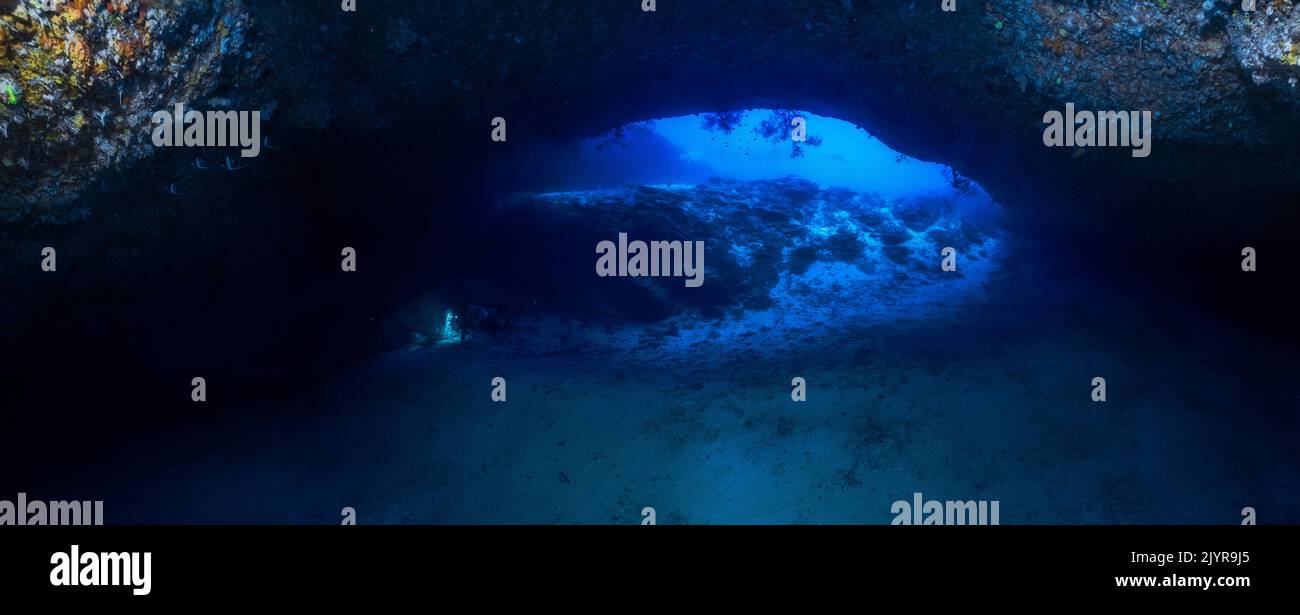 The entrance to the underwater cave. A panorama taken at the entrance to the cave at a depth of just under 60 metres. Underwater cave, Mayotte Stock Photo