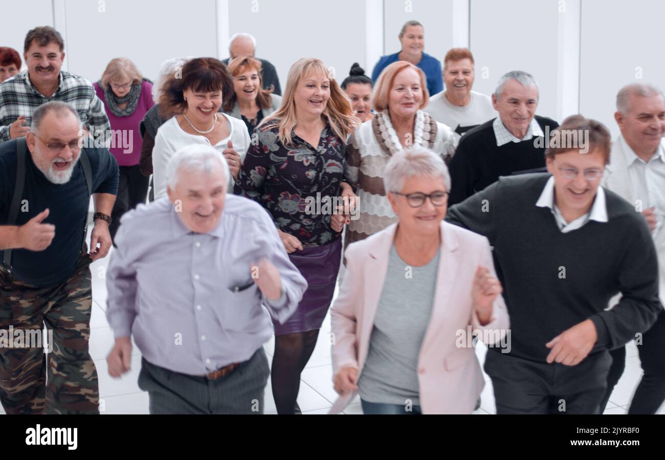 Successful business team running in the office hall Stock Photo - Alamy