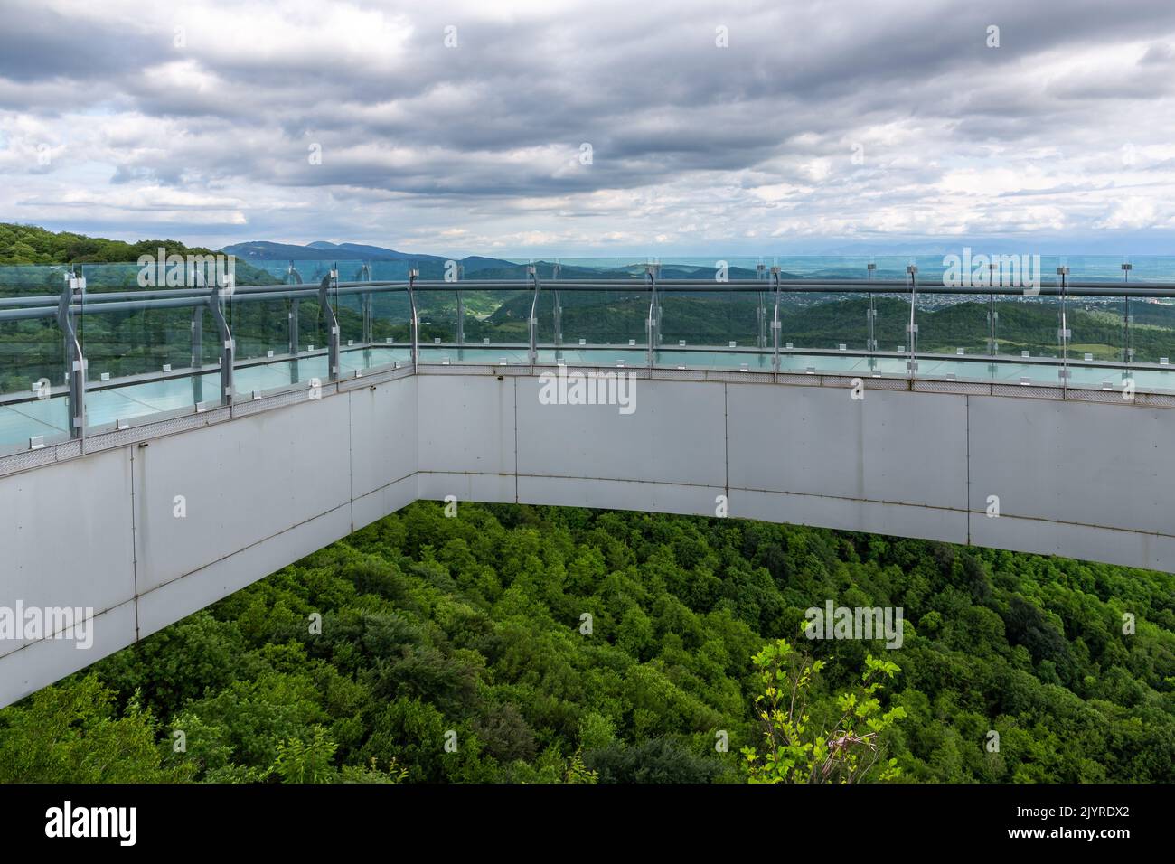 Glass walkway (observation deck) with transparent floor overlooking natural scenery of Sataplia Nature Reserve in Georgia. Stock Photo