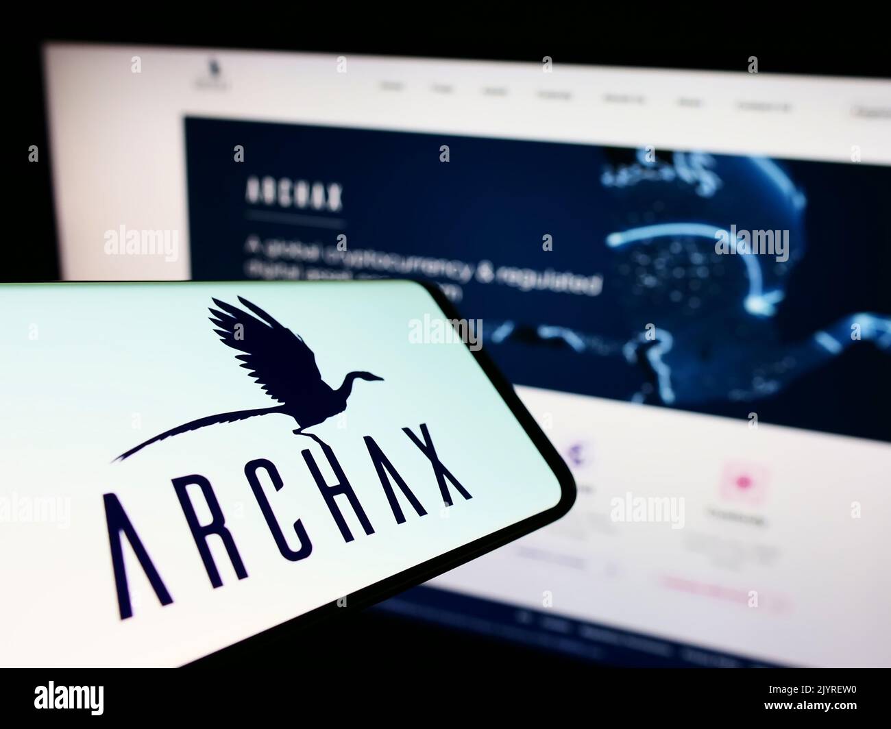 Mobile phone with logo of British crypto company Archax Ltd. on screen in front of business website. Focus on center-right of phone display. Stock Photo