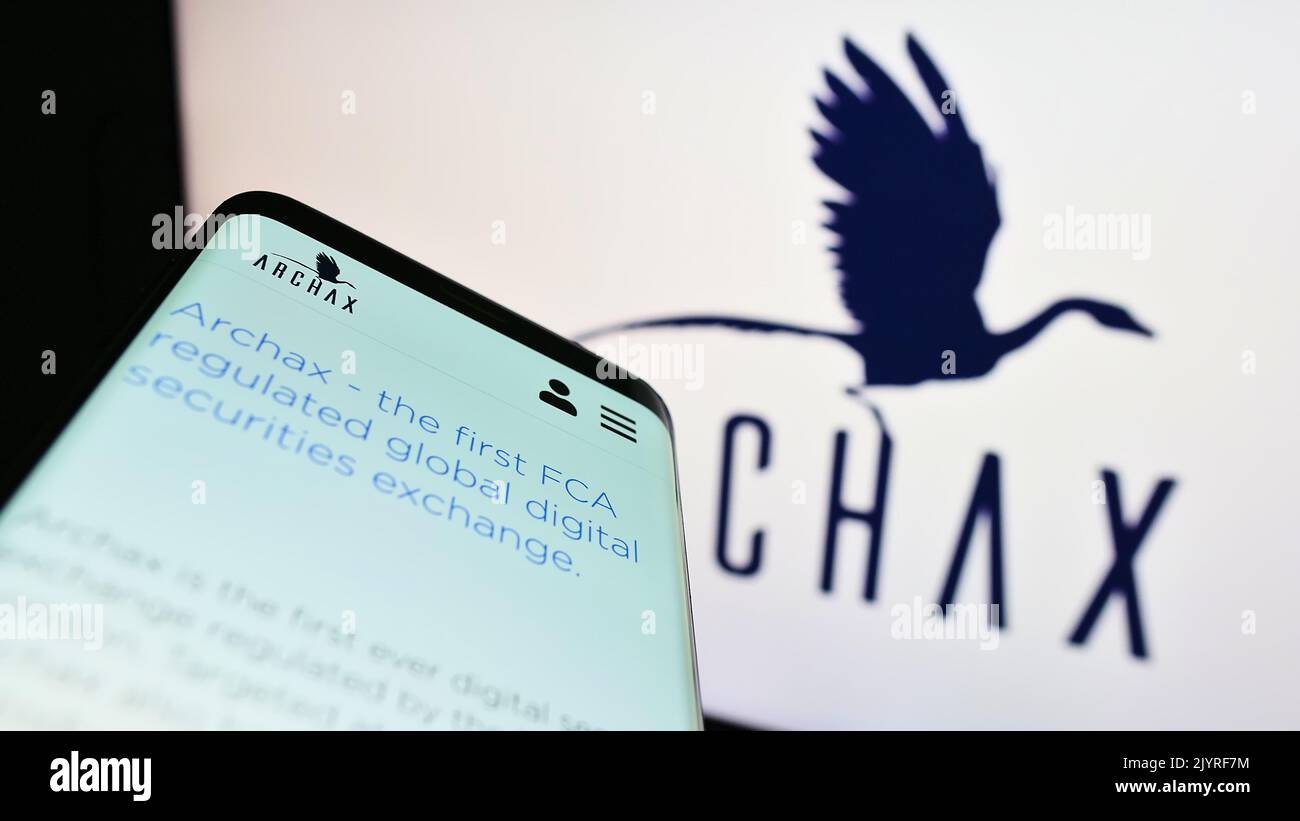Smartphone with webpage of British crypto company Archax Ltd. on screen in front of business logo. Focus on top-left of phone display. Stock Photo