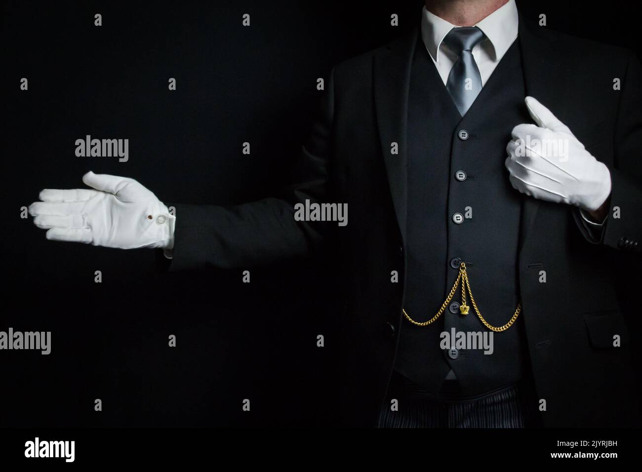 Portrait of Butler in Dark Suit and White Gloves Standing With