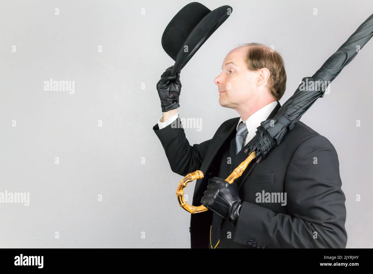 Businessman tipping bowler hat hires stock photography and images Alamy