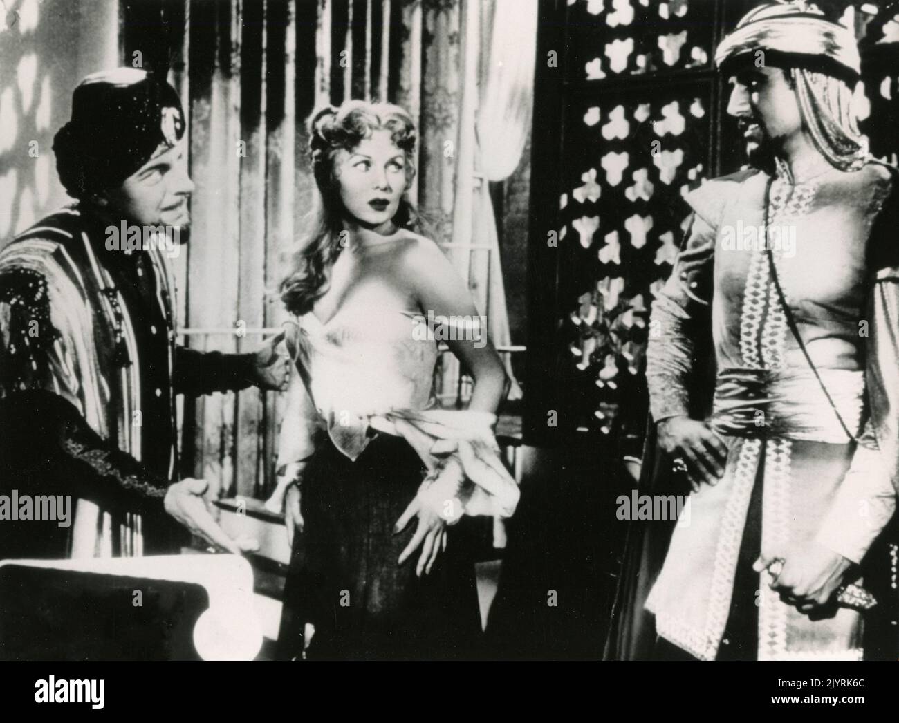 Actors Philip van Zandt, Rhonda Fleming, and Bart Roberts in the movie Yankee Pasha, USA 1954 Stock Photo