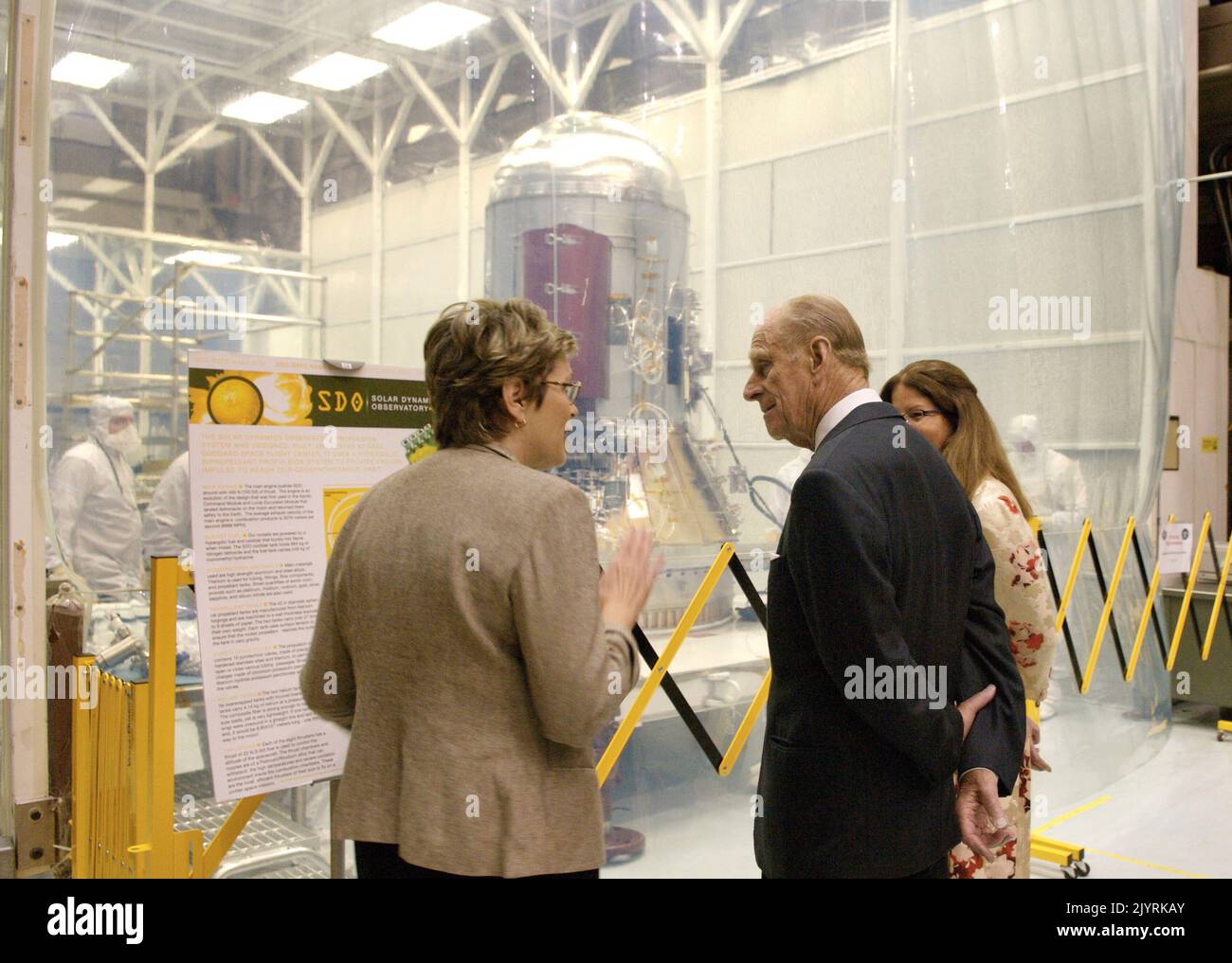 SDO program Manager, left, Deescribes the SDO project to Prince Philip in from of Spacecraft Clean tent. Photo Credit: 'NASA/Chris Gunn' Stock Photo