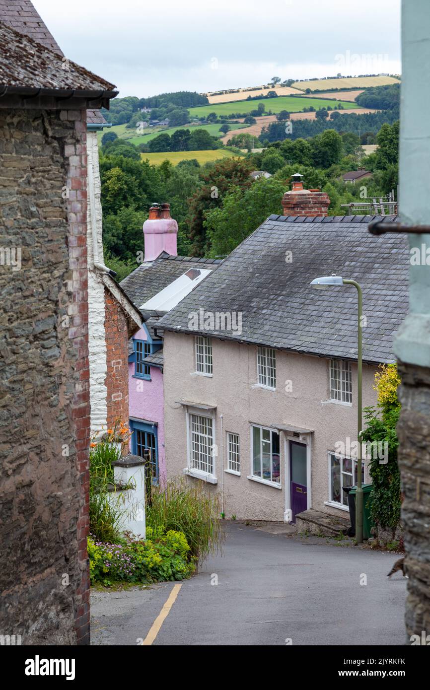A narrow road in Bishops Castle with the Shropshire hills in the distance. Stock Photo
