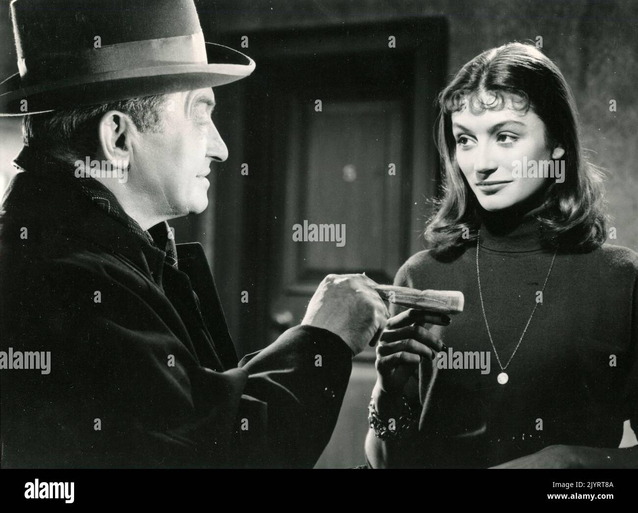 Actor Claude Rains and actress Anouk Aimée in the movie The Man Who Watched Trains Go By, UK 1952 Stock Photo