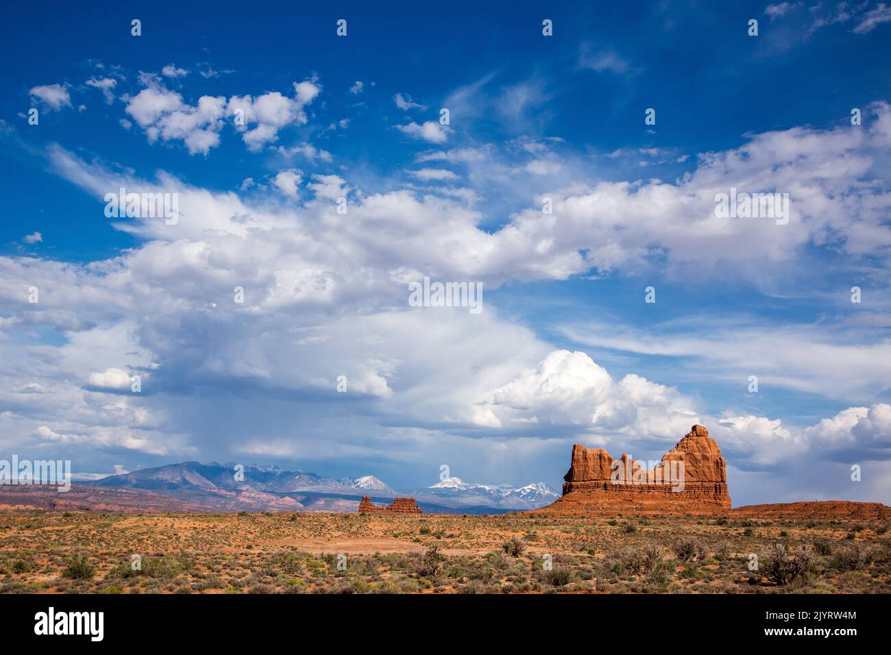 Cumulus thunderhead clouds developing over the La Sal Mountains and Arches National Park, Moab, Utah. Stock Photo
