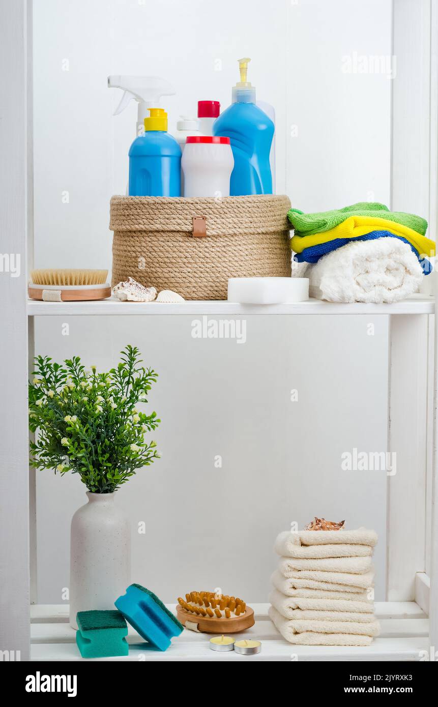 Hand knitted jute basket with a lid with detergents and towels in the