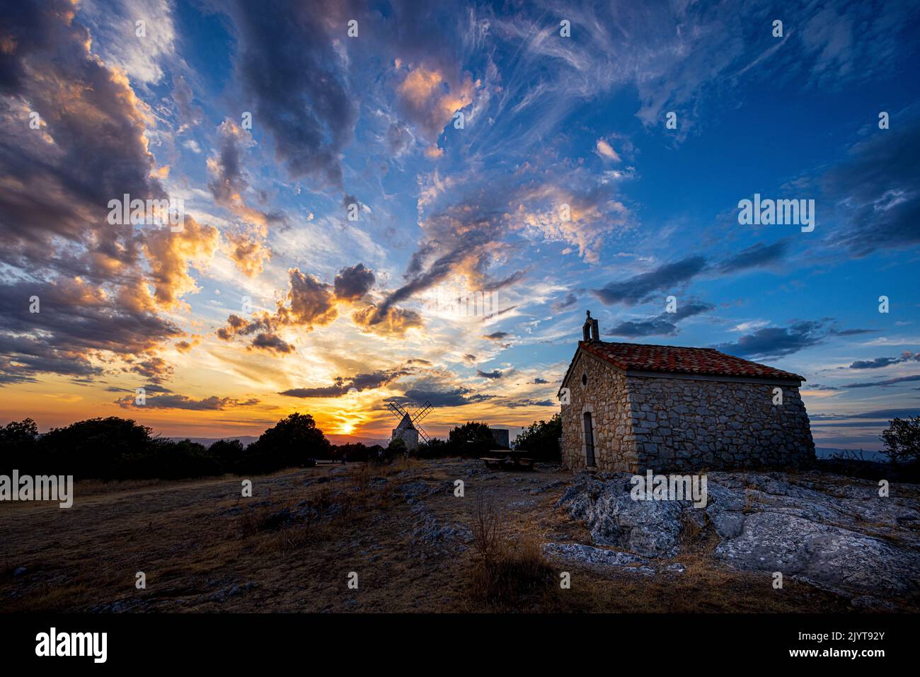 The Mill of Saint Julien de Montagnier and the chapel of the Annonciade at sunset, Var, France Stock Photo