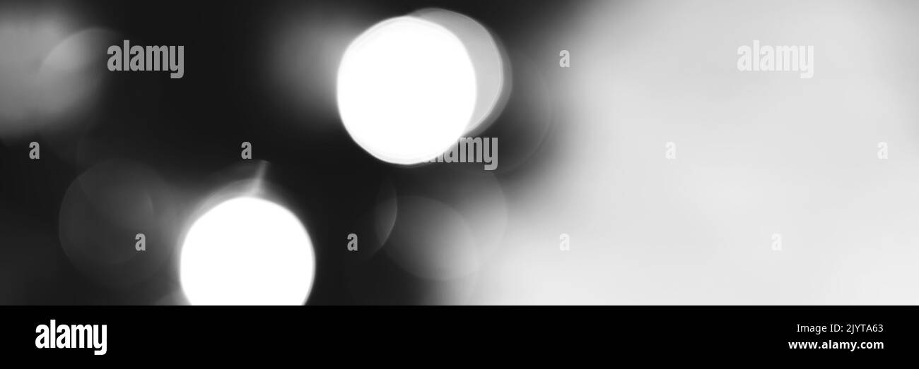 Blurred lights black and white background, banner texture. Abstract