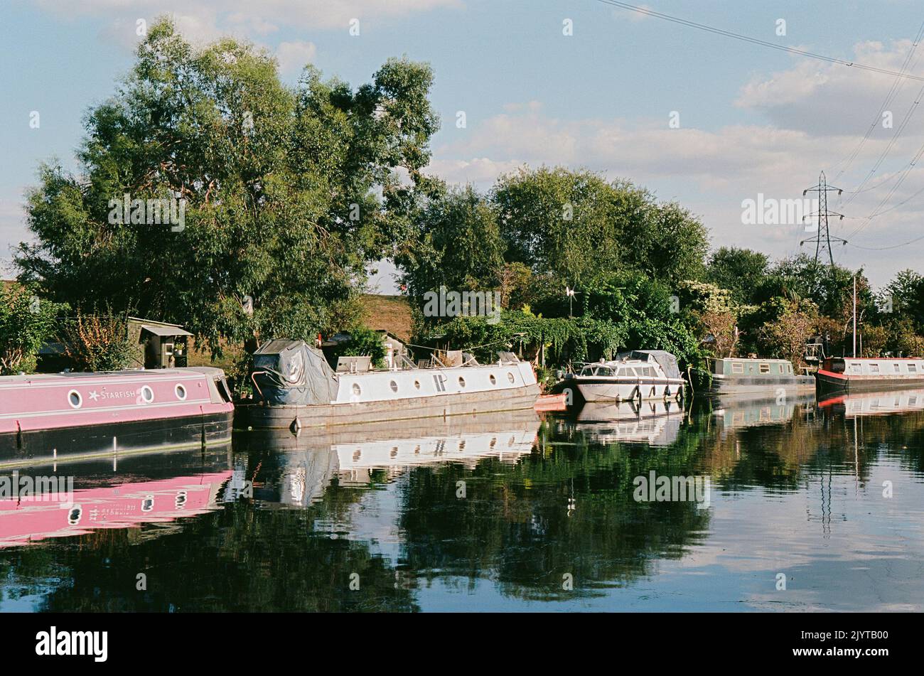 The River Lea on Tottenham Marshes, North London, in the summer of 2022, with narrowboats Stock Photo