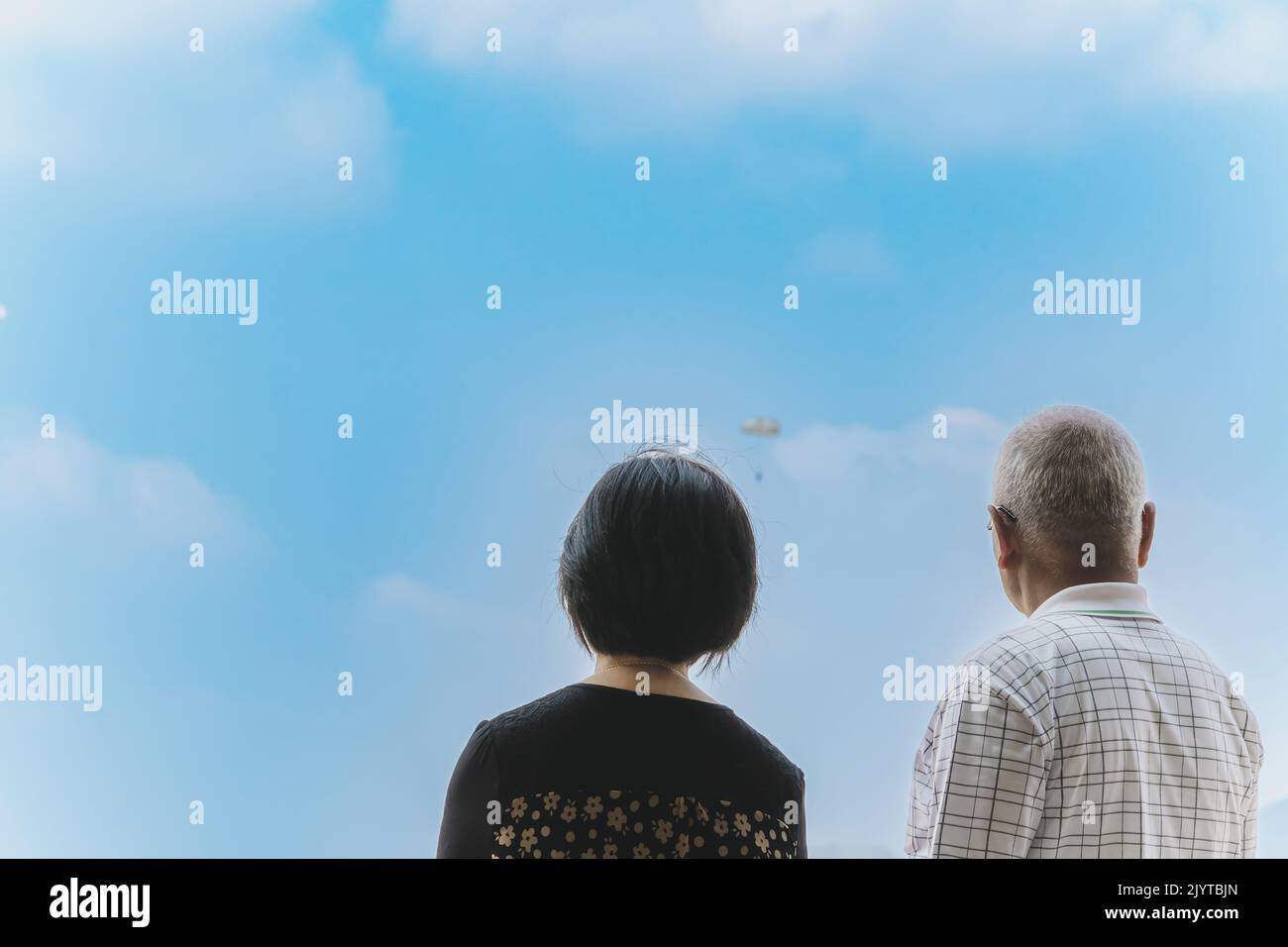 Back view of Asian parents looking with worry and concern during