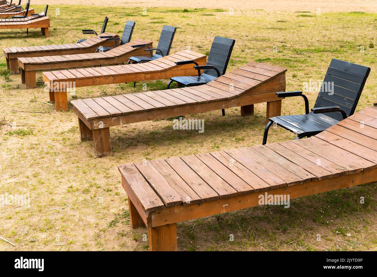 wooden deck chairs and chairs on the sandy beach of the lake Stock ...