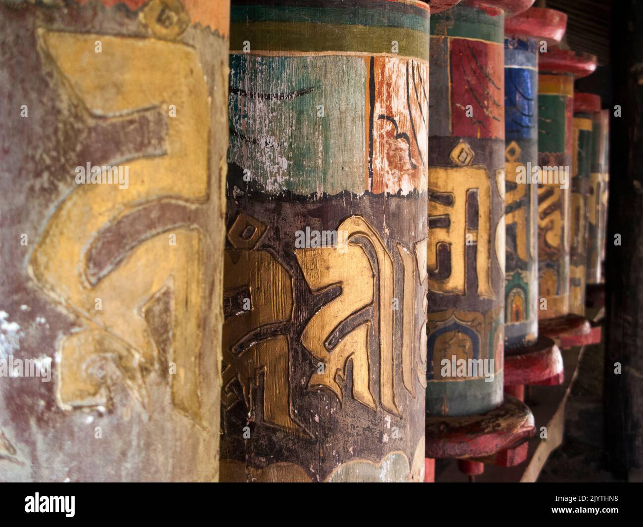 Buddhist prayer wheels carved from timber wood and used to practise Tibetan Buddhism in China, at a local temple in a village outside Songpan ancient town in northern Sichuan province, China. PRC. (126) Stock Photo