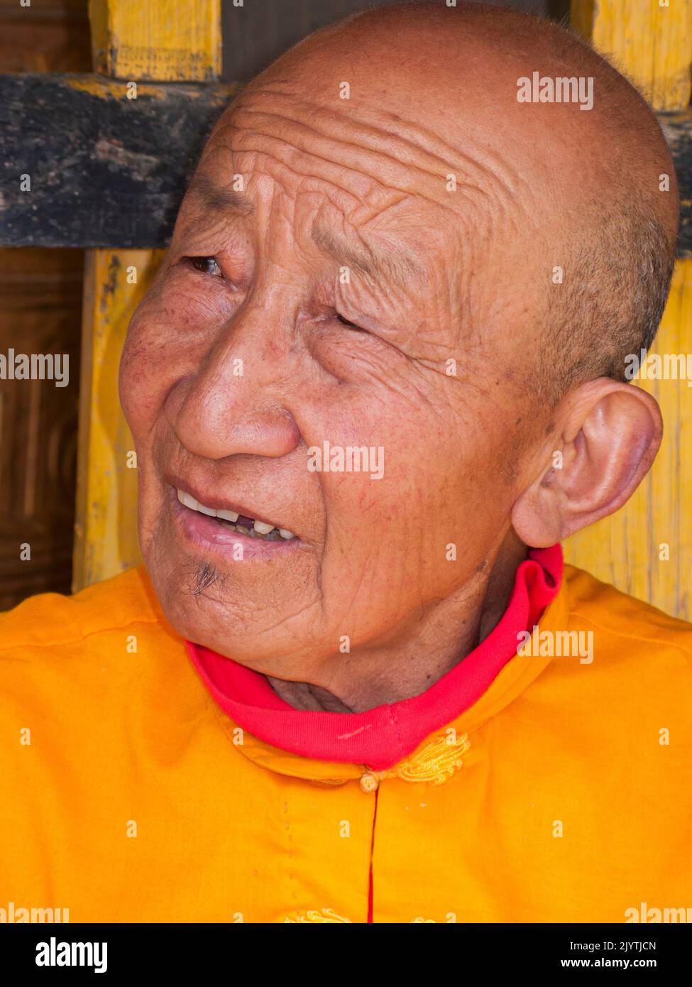 Portrait of local person wearing Buddhist clothes, an elderly old man of pension age, of Tibetan heritage but living in China, resident of a small village outside Songpan ancient town in northern Sichuan province. PRC. China (126) Stock Photo