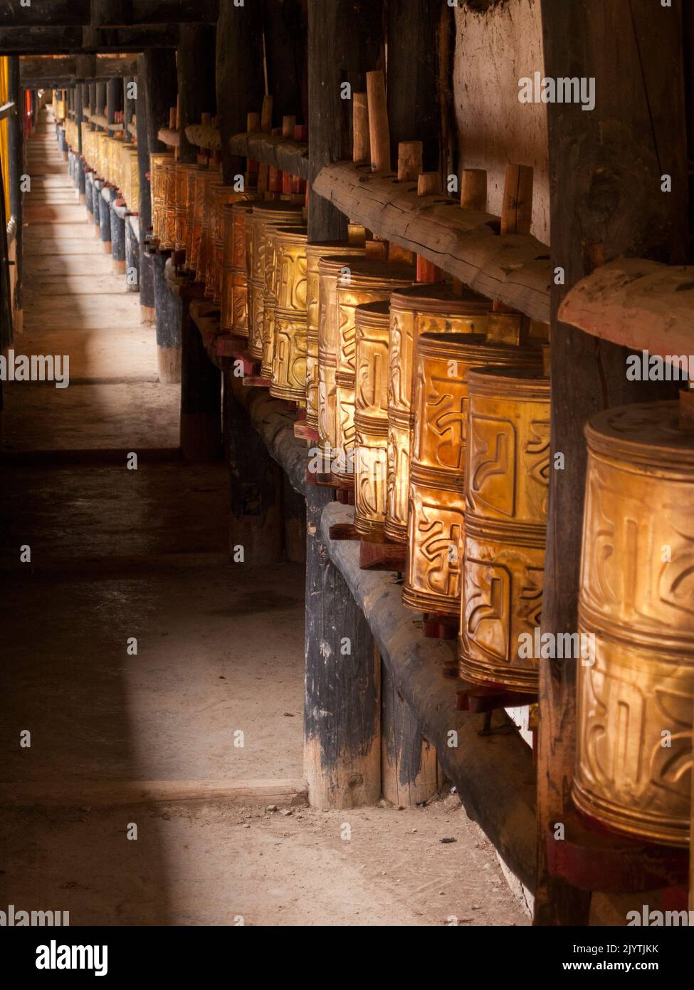 Buddhist prayer wheels used to practice Tibetan Buddhism in China, at a local temple in a village outside Songpan ancient town in northern Sichuan province, China. PRC. (126) Stock Photo