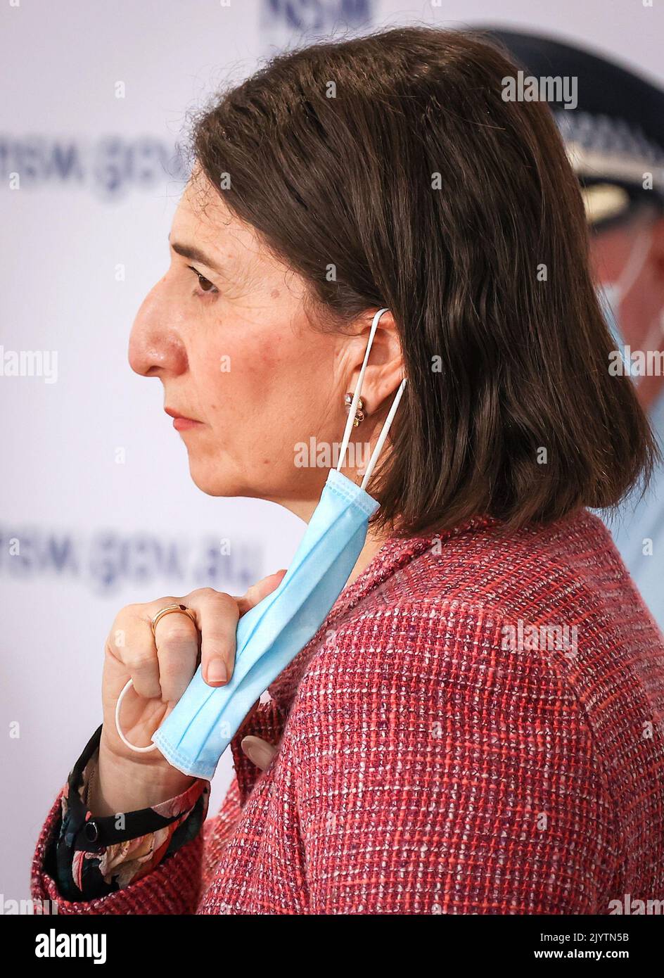 NSW Premier Gladys Berejiklian adjusts her face mask during a press ...