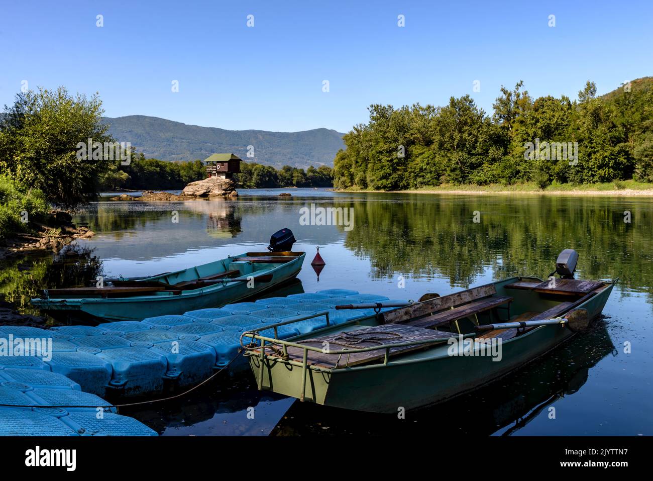 Two fishing boats in front of the famous wooden house on the Drina river in Bajina Basta, Serbia on summer sunny day. Stock Photo