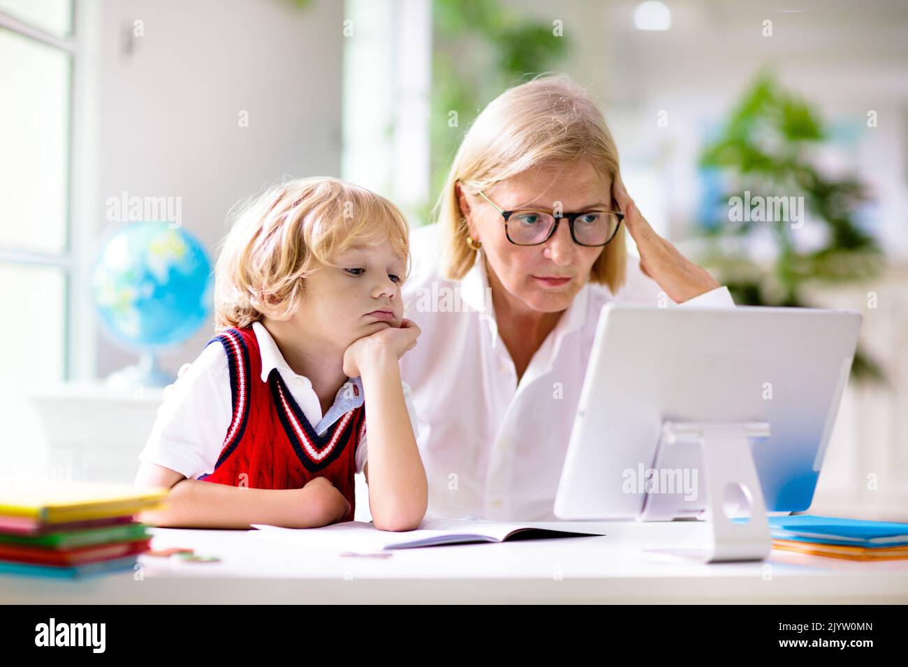 Very happy child playing game online with laptop stay at home. Asian boy  student online learning class study online video call teacher Stock Photo -  Alamy