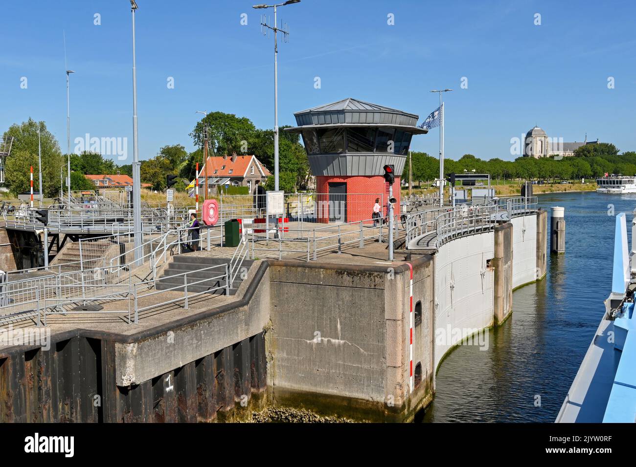 Veere, Netherlands - August 2022: River cruise ship entering the canal lock near the town with lock gate open Stock Photo