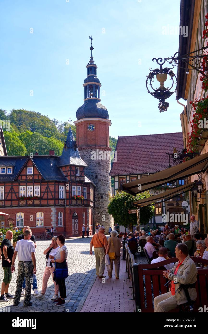 Stolberg, Germany, September 4, 2022: Tourists in a sidewalk cafe on the market square in front of the bell tower of the historic old town Stock Photo