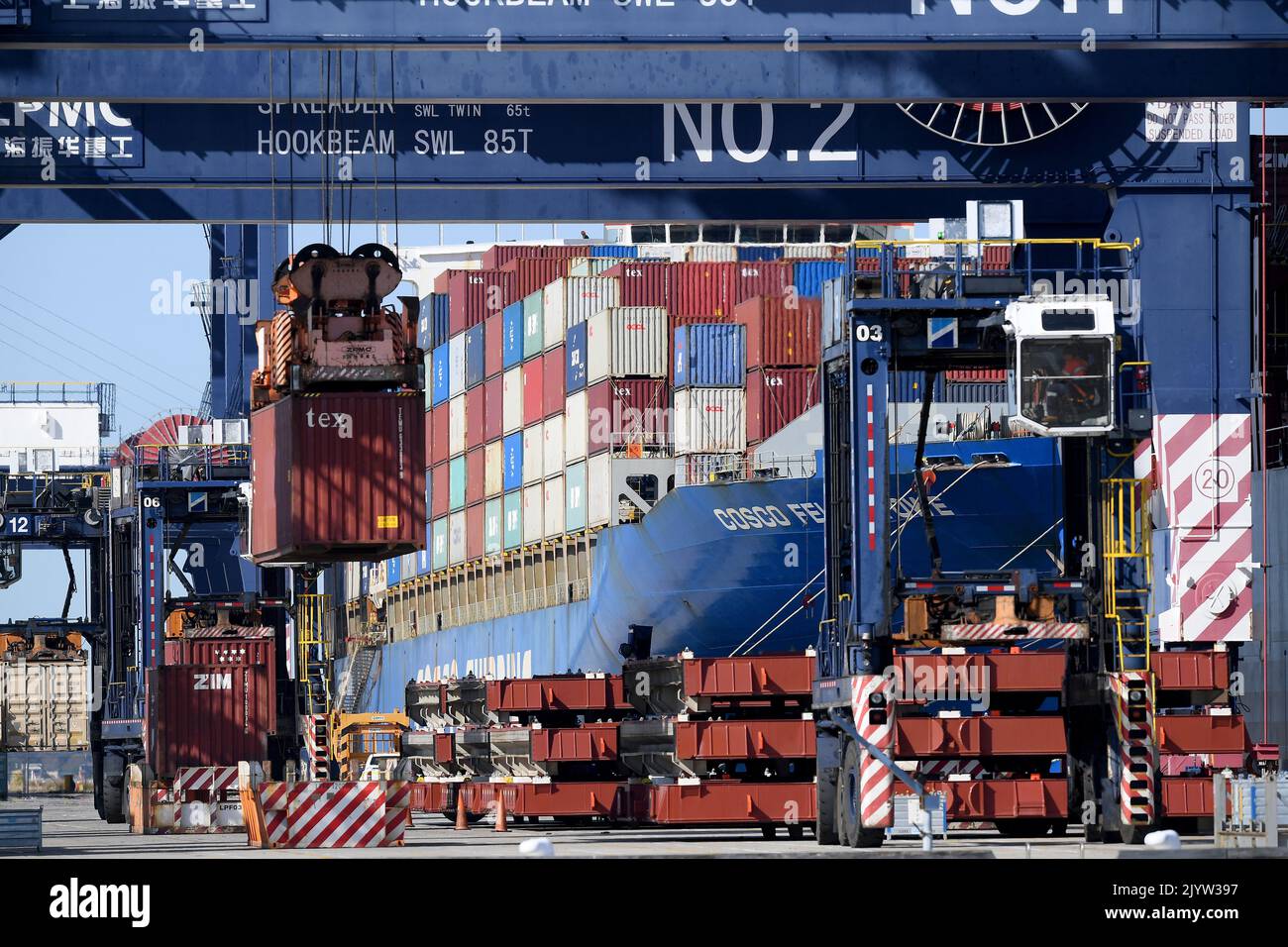 Shipping containers are loaded onto a ship at Port Botany in Sydney, Wednesday, September 1
