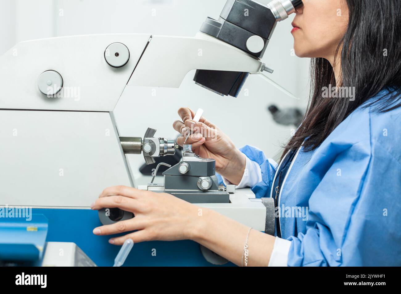 Female scientist placing a sample on a transmission electron microscopy