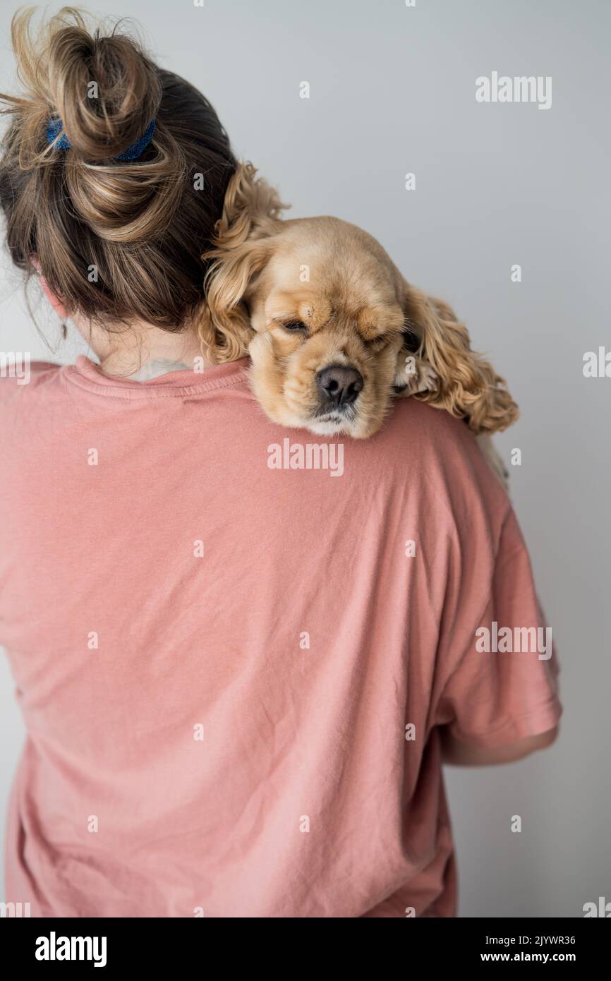 Woman holding puppy on shoulder hi-res stock photography and images - Alamy